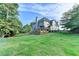 Backyard view of home and deck with green lawn at 306 Mill Rdg, Canton, GA 30114