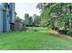 Expansive backyard with lush green grass and mature trees offering plenty of space and privacy at 306 Mill Rdg, Canton, GA 30114
