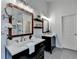 Bathroom featuring double vanities with dark cabinets, quartz countertops and decorative mirrors at 306 Mill Rdg, Canton, GA 30114