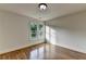 Bedroom with hardwood floors, neutral tones, and window offering tree-filled view to the outside at 306 Mill Rdg, Canton, GA 30114