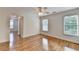 Bedroom featuring hardwood floors, neutral walls, and abundant natural light from two windows at 306 Mill Rdg, Canton, GA 30114