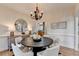 Stylish dining area with modern lighting, decor, and an archway into the hall at 306 Mill Rdg, Canton, GA 30114
