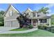 Charming two-story home with a manicured lawn, two-car garage, and inviting front porch at 306 Mill Rdg, Canton, GA 30114