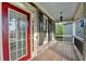 Inviting front porch with a red door, stone accents, and black shutters adding curb appeal at 306 Mill Rdg, Canton, GA 30114