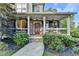 Inviting front porch with stone accents, a red door, and manicured landscaping at 306 Mill Rdg, Canton, GA 30114
