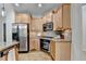 Well-equipped kitchen with stainless steel appliances, granite countertops, and light wood cabinets at 306 Mill Rdg, Canton, GA 30114