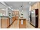 Spacious kitchen with granite counters, wood cabinets, stainless appliances and kitchen island at 306 Mill Rdg, Canton, GA 30114