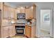 Compact kitchen with wood cabinets, granite countertops and stainless steel appliances at 306 Mill Rdg, Canton, GA 30114