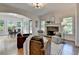 Open-concept living room with a stone fireplace, hardwood floors, and serene backyard views at 306 Mill Rdg, Canton, GA 30114