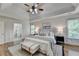 Elegant main bedroom featuring tray ceilings, hardwood floors, and ensuite bathroom access at 306 Mill Rdg, Canton, GA 30114