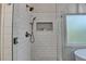 Close up view of a tiled glass enclosed shower with dual shower heads and built-in niche at 306 Mill Rdg, Canton, GA 30114