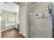 Bright bathroom featuring a tub, glass shower, and wood-look floor at 1612 Silver Oak Dr, Austell, GA 30106
