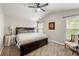 Bedroom featuring a plush bed, ceiling fan, and natural light at 1612 Silver Oak Dr, Austell, GA 30106