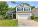 Charming two-story home features a well-manicured lawn and attached two-car garage at 1612 Silver Oak Dr, Austell, GA 30106