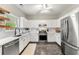Modern kitchen features white cabinets, stainless steel appliances, and tile flooring at 1612 Silver Oak Dr, Austell, GA 30106