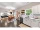 Kitchen view into dining area featuring stainless steel appliances, white cabinets, and a breakfast nook at 1612 Silver Oak Dr, Austell, GA 30106