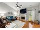 Open concept living room boasts hardwood floors, vaulted ceilings, and cozy fireplace at 1612 Silver Oak Dr, Austell, GA 30106