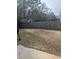 This backyard features a shed and a wood fence, along with dried grass at 2682 Field Spring Dr, Lithonia, GA 30058