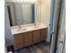 Bathroom featuring double vanity with marble countertop and large mirror, blending functionality and style at 2682 Field Spring Dr, Lithonia, GA 30058