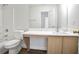Accessible bathroom featuring a marble countertop vanity and a coordinated toilet and shower-tub setup at 2682 Field Spring Dr, Lithonia, GA 30058