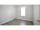 This bedroom features wood flooring, white walls, and a window to let in natural light at 2682 Field Spring Dr, Lithonia, GA 30058