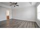 Large bedroom with modern flooring, adjacent bathroom, and ample natural light through a side window at 2682 Field Spring Dr, Lithonia, GA 30058