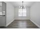 Dining room with contemporary chandelier, new floors, and trim accents at 2682 Field Spring Dr, Lithonia, GA 30058