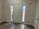 Bright foyer with new grey floors and sidelight windows flanking the front door at 2682 Field Spring Dr, Lithonia, GA 30058