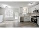 Modern kitchen with stainless appliances, white cabinets, and ample room for dining at 2682 Field Spring Dr, Lithonia, GA 30058