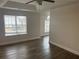 Bright living room featuring new floors, ample light from large windows, and a modern ceiling fan at 2682 Field Spring Dr, Lithonia, GA 30058