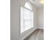 Close-up of an arched window with blinds, highlighting natural light and architectural detail at 2682 Field Spring Dr, Lithonia, GA 30058