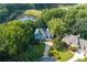 Stunning lakefront property with lush landscaping, mature trees, and a private driveway at 3525 Stone Cliff Way, Woodstock, GA 30189