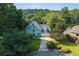 Aerial view of a charming home surrounded by lush greenery and manicured lawns at 3525 Stone Cliff Way, Woodstock, GA 30189