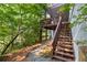 Stairs lead to back deck from backyard and a wooded area at 3525 Stone Cliff Way, Woodstock, GA 30189