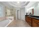 Luxurious primary bathroom with soaking tub, glass shower, and dual vanities at 3525 Stone Cliff Way, Woodstock, GA 30189
