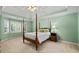 Serene bedroom with a tray ceiling and natural light at 3525 Stone Cliff Way, Woodstock, GA 30189