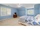 Upstairs bedroom painted blue with lots of natural light and neutral colored carpet at 3525 Stone Cliff Way, Woodstock, GA 30189