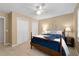 Comfortable bedroom with two closets, side table, and bed with blue coverlet at 3525 Stone Cliff Way, Woodstock, GA 30189