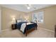 Cozy bedroom with a comfortable bed, side table, and large window with plantation shutters at 3525 Stone Cliff Way, Woodstock, GA 30189