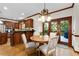 Eat-in kitchen featuring a breakfast area with a round wooden table, doors to the deck, and cherry cabinets at 3525 Stone Cliff Way, Woodstock, GA 30189