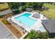 Aerial view of a community pool with seating areas, landscaping, and playground at 3525 Stone Cliff Way, Woodstock, GA 30189