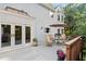 Outdoor deck with dining furniture, plants, and views of the backyard and surrounding trees at 3525 Stone Cliff Way, Woodstock, GA 30189