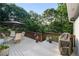 Spacious deck offering outdoor dining and grilling, surrounded by lush green trees at 3525 Stone Cliff Way, Woodstock, GA 30189