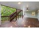 Covered porch with wood floors, stairs to the yard, and a ceiling fan for comfort at 3525 Stone Cliff Way, Woodstock, GA 30189