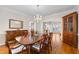 Bright dining room featuring hardwood floors, chandelier, and large wooden table at 3525 Stone Cliff Way, Woodstock, GA 30189
