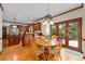 Open layout dining room connecting the kitchen and deck with hardwood floors at 3525 Stone Cliff Way, Woodstock, GA 30189