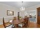Elegant dining room features hardwood floors, a crystal chandelier, and traditional furnishings at 3525 Stone Cliff Way, Woodstock, GA 30189