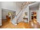 Welcoming foyer with hardwood floors, staircase, and views into living spaces at 3525 Stone Cliff Way, Woodstock, GA 30189