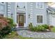 Elegant front entrance with stone pathway and well-manicured landscaping at 3525 Stone Cliff Way, Woodstock, GA 30189