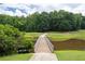 Beautiful golf course view from a wooden bridge over a pond surrounded by lush greenery at 3525 Stone Cliff Way, Woodstock, GA 30189